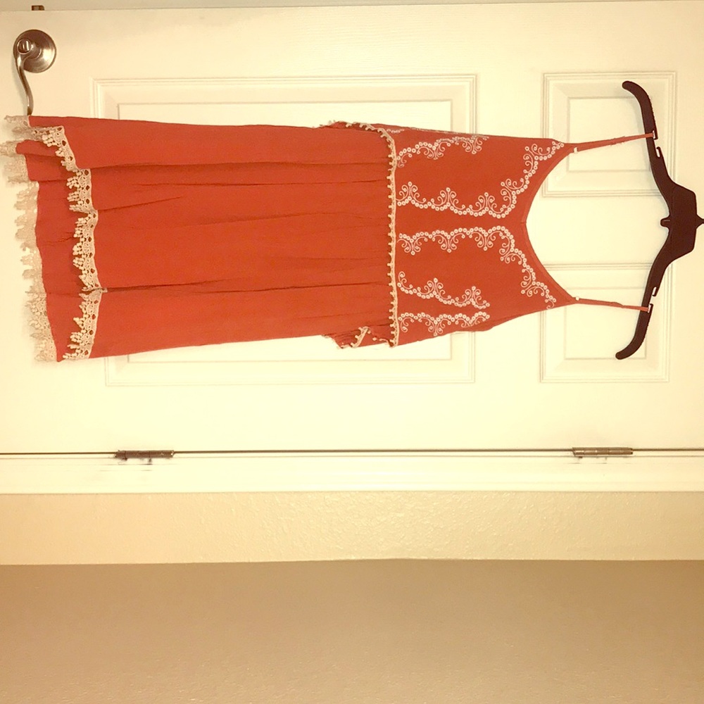 Orange sun dress with cream lace detail.